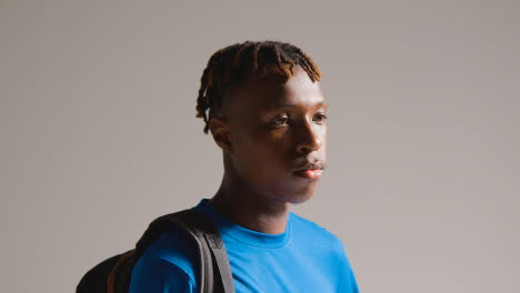 Studio-Shot-Of-Young-Man-Playing-Football-Or-Other-Sport-Walking-To-Training-With-Kit-Bag-1