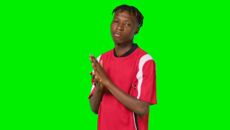 Studio-Portrait-Of-Young-Male-Footballer-Wearing-Club-Kit-Against-Green-Screen
