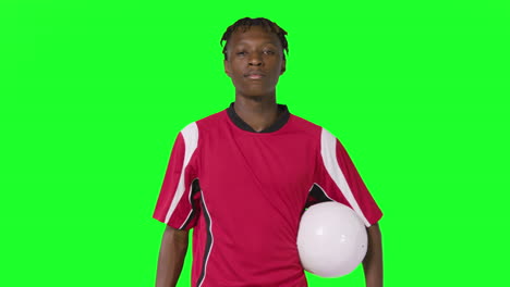 Studio-Portrait-Of-Male-Footballer-Wearing-Club-Kit-With-Ball-Under-Arm-Against-Green-Screen