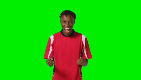 Studio-Portrait-Of-Young-Male-Footballer-Wearing-Club-Kit