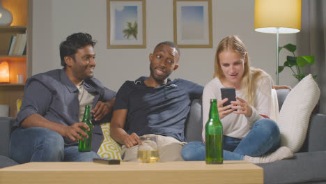 Multi-Cultural-Friends-Ordering-Takeaway-Food-Delivery-On-Mobile-Phone-Sitting-On-Sofa-At-Home-Together-8