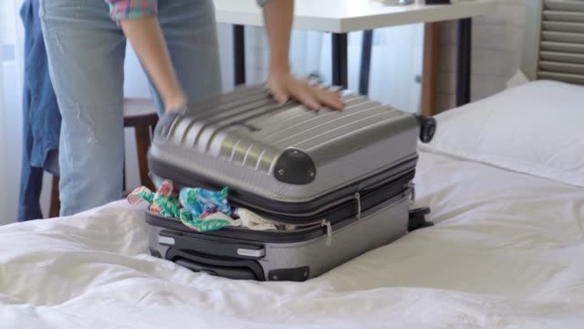 woman-squeezing-and-dragging-the-suitcase