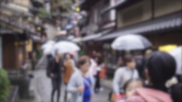 Tourists-walking-in-the-street-with-umbrella-raining-in-Kyoto