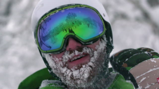 Snowboarder-Skifahrer-Mountainman-tragen-Helm-großen-Bart-voller-Schnee,-die-gefrorene-Gesicht-abschütteln