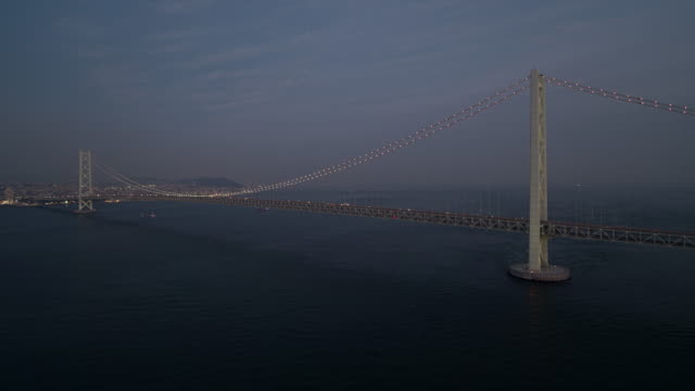 Aerial---Full-view-of-the-Akashi-Kaikyo-Bridge-right-after-sunset-Zoom-out