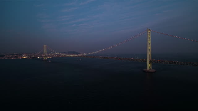 Aerial---Full-view-of-the-Akashi-Kaikyo-Bridge-right-after-sunset-Zoom-in