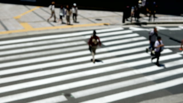 Anonymous-crowd-of-people-walking-on-crosswalk-or-zebra-crossing-in-city