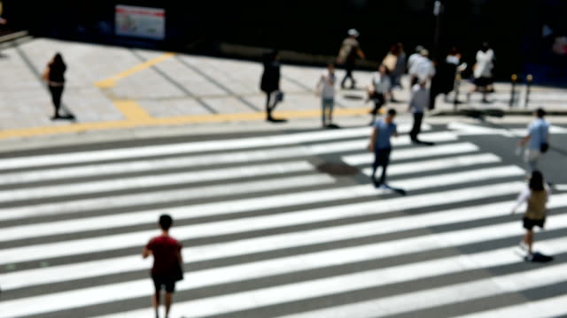Anonymous-crowd-of-people-walking-on-crosswalk-or-zebra-crossing-in-city