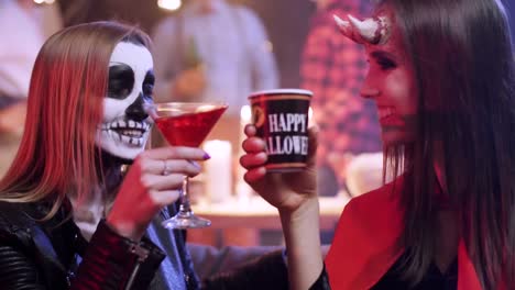 Friends-in-costumes-drinking-alcohol-at-the-halloween-party