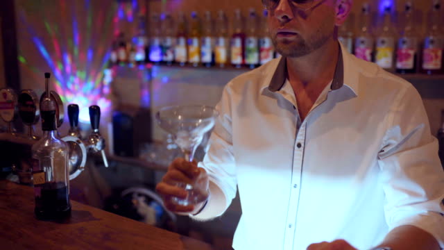 man-bartender-working-on-brew-dip-and-drop-fruit-cocktail-to-make-fruit-cocktail-serving