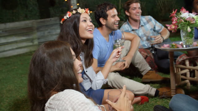 Group-Of-Friends-Enjoying-Night-Time-Party-In-Garden