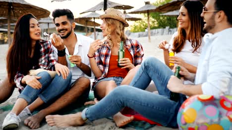 Group-of-happy-friends-partying-on-beach