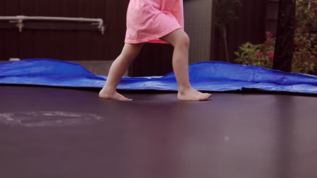 Happy-Girl-Jumping-on-Trampoline.-Funny-Action-in-4k,-UHD