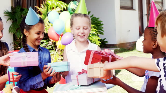 Smiling-girl-receiving-gifts-from-friends-4k