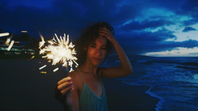 Woman-with-Sparkler-at-Sunset