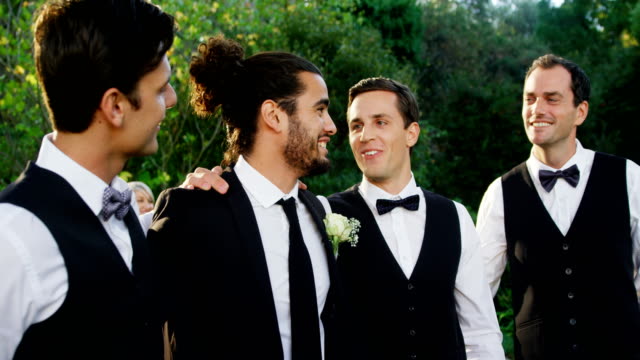 Groom-and-groomsmen-happily-talking-with-each-other-4K-4k