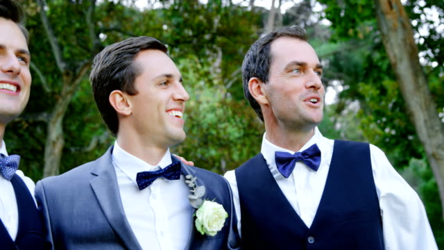 Groom-and-groomsmen-happily-hugging,-talking-4K-4k