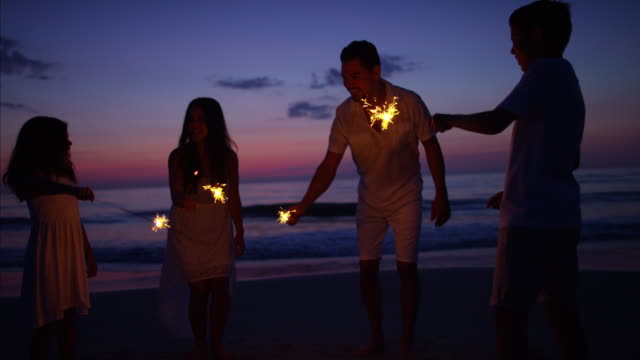 Silhouette-of-Latin-American-family-with-fun-sparklers