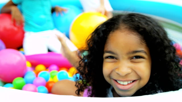 Portrait-of-African-American-girl-in-ball-pool
