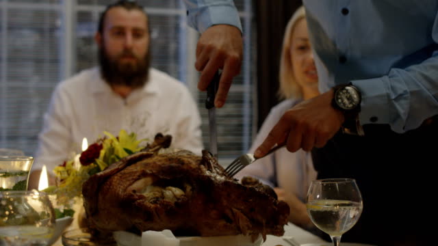 Man-carving-turkey-on-holiday-dinner