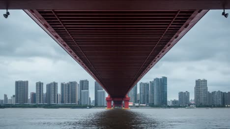 cloudy-weather,-red-Bridges-on-the-water-and-distant-cities.Time-lapse-photography