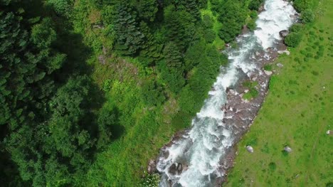 drone-flying-above-the-stream-in-the-mountain