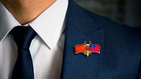 Businessman-Walking-Towards-Camera-With-Friend-Country-Flags-Pin-China---Samoa