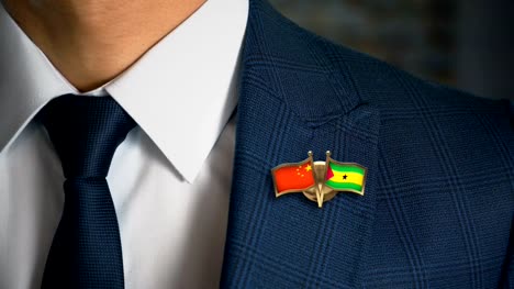 Businessman-Walking-Towards-Camera-With-Friend-Country-Flags-Pin-China---Sao-Tome-and-Principe
