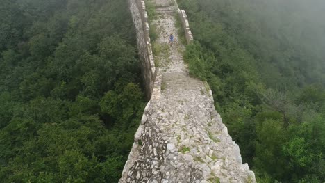 Aerial-view-of-woman-hiker-hiking-on-the---great-wall