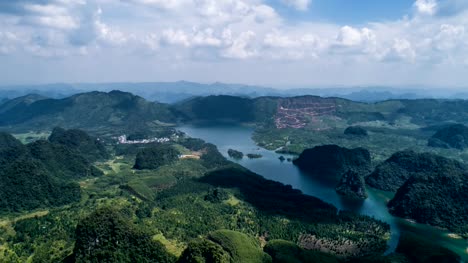 Aerial-view-of-Karst-mountains-and-lake-on-sunny-day,-timelapse