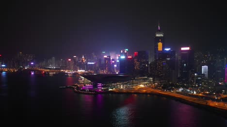 night-time-illuminated-hong-kong-city-downtown-traffic-bay-aerial-panorama-4k