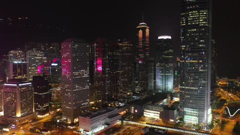 noche-iluminada-hong-kong-ciudad-Centro-Bahía-aérea-panorama-4k