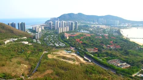Small-houses-and-skyscrapers-between-the-mountains-aerial-view
