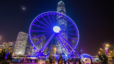 panorama-de-rueda-famosa-bahía-del-ciudad-de-hong-kong-de-China-la-noche-iluminación-4k-lapso-de-tiempo