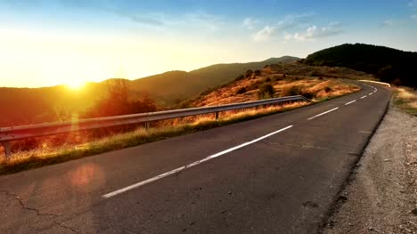 High-altititude-Alps-mountain-road-and-sunset-setting-down-BACKGROUND