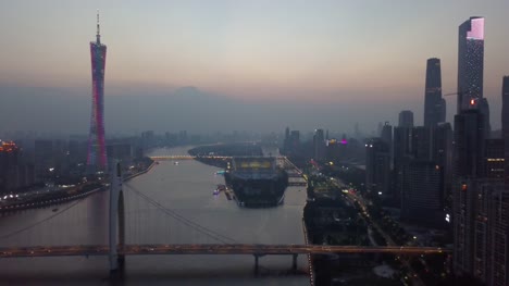 puesta-del-sol-ciudad-de-guangzhou-céntrico-Cantón-torre-liede-Puente-Río-panorama-aéreo-4k-china