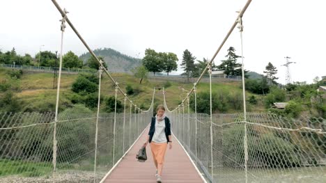 Young-girl-walks-on-the-suspension-bridge---Georgia