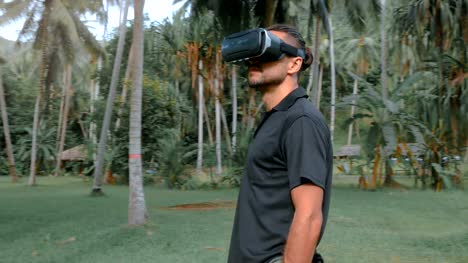 Man-using-virtual-reality-headset-in-the-jungle