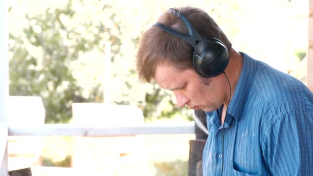 Man-working-in-nature-in-headphones.