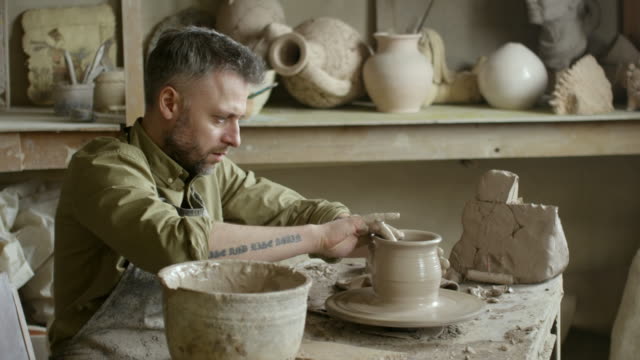 Artisan-Wetting-Hands-and-Throwing-Vase