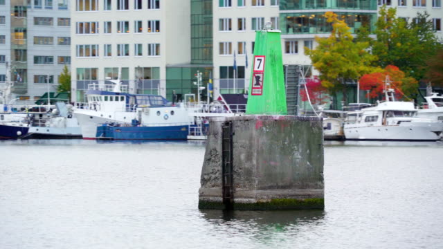 A-green-cement-pole-in-the-middle-of-the-lake-in-Stockholm-Sweden