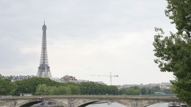 Parisian-and-French-famous-Eiffel-tower-near-river-Seine-by-the-day-slow-tilt-4K-2160p-30fps-UltraHD-video---Tilting-on-famous-scenery-of-France-and-Paris-4K-3840X2160-UHD-footage