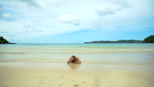 Man-lying-on-the-beach