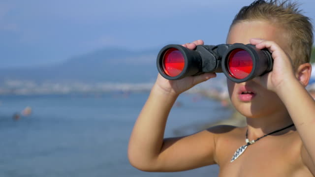 Child-exploring-the-sea-with-binoculars