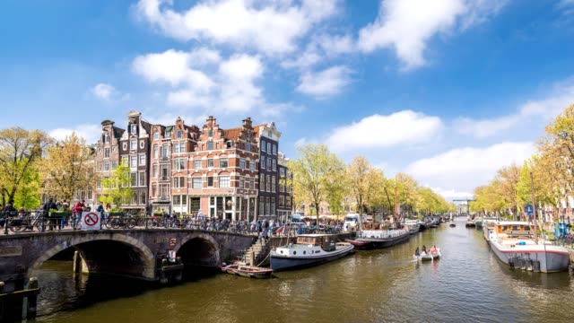 Amsterdam-city-skyline-timelapse-at-canal-waterfront,-Amsterdam,-Netherlands,-4K-Time-Lapse