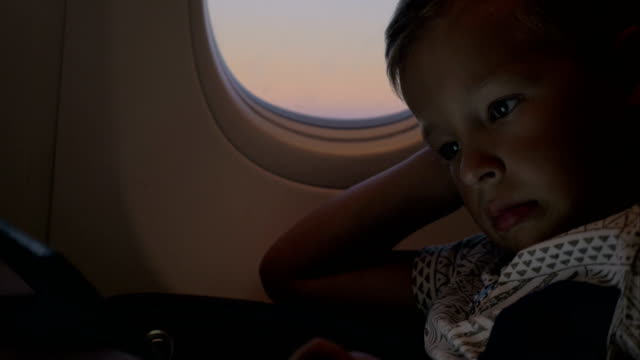 Child-using-tablet-PC-in-airplane