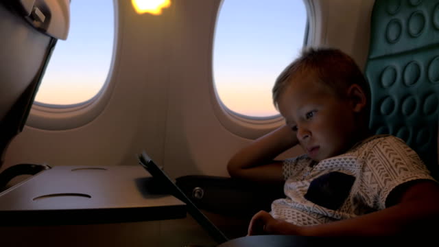 Bored-kid-with-pad-in-plane