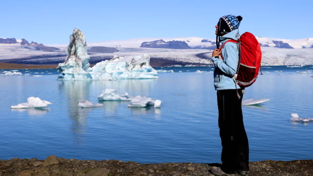 Young-woman-admires-the-beauty-of-the-glacial-lagoon-Jokulsarlon
