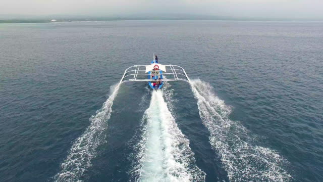 Drone-Shot-of-Filipino-Boat-Moving-In-The-Beautiful-Tropical-Sea.