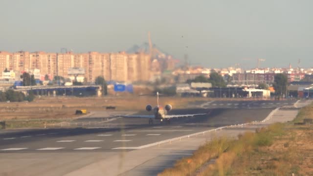 jet-taking-off-at-airport-runway,-rear-view